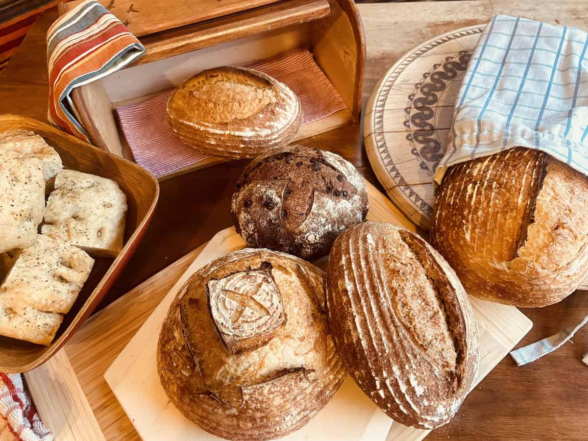 Boule and batard loaves and a bowl of focaccia