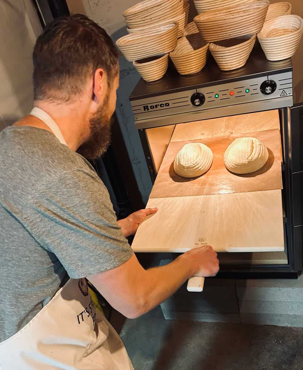 putting bread in oven